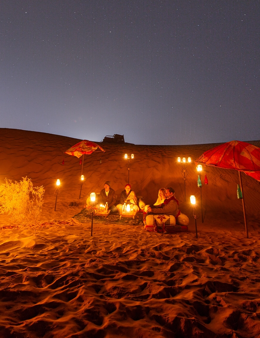 Candle-lit private dinner set up on the dunes